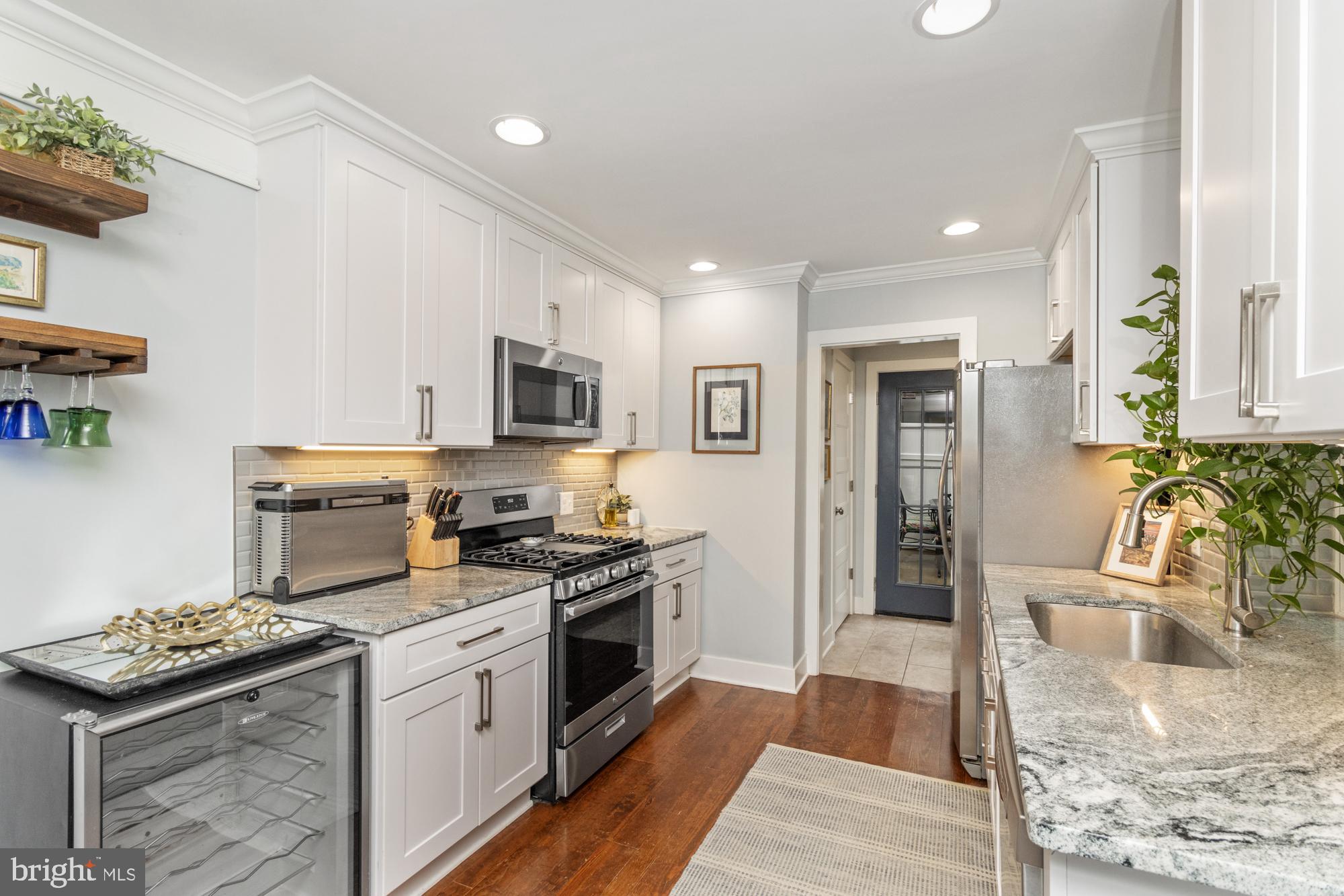 217 East Cross Street Baltimore, MD 21230 - Photo 11 of 50 a kitchen with granite countertop a sink and steel appliances