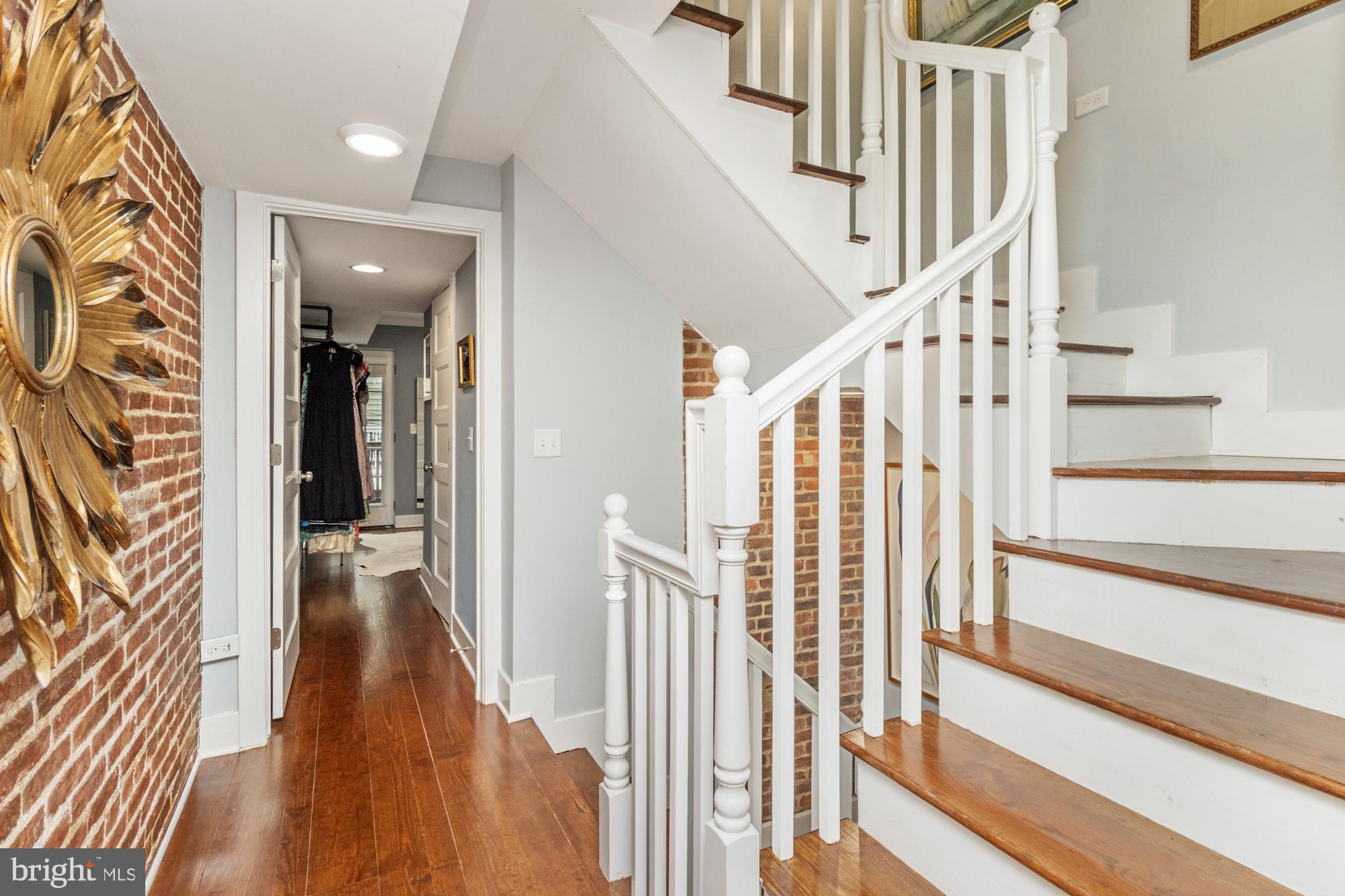 217 East Cross Street Baltimore, MD 21230 - Photo 18 of 50 a view of a hallway with wooden floor and staircase
