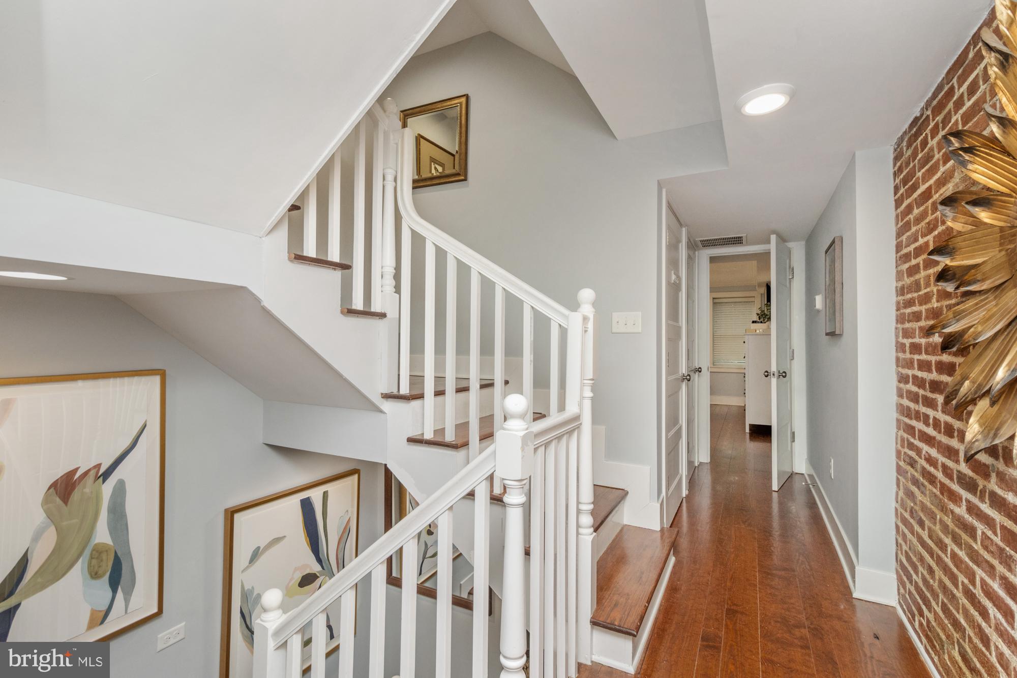 217 East Cross Street Baltimore, MD 21230 - Photo 19 of 50 a view of staircase with wooden floor and white walls