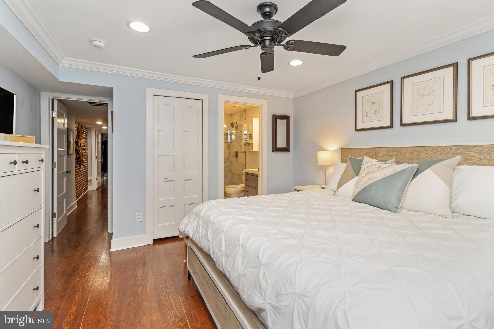 217 East Cross Street Baltimore, MD 21230 - Photo 23 of 50 a bedroom with a large bed and a chandelier