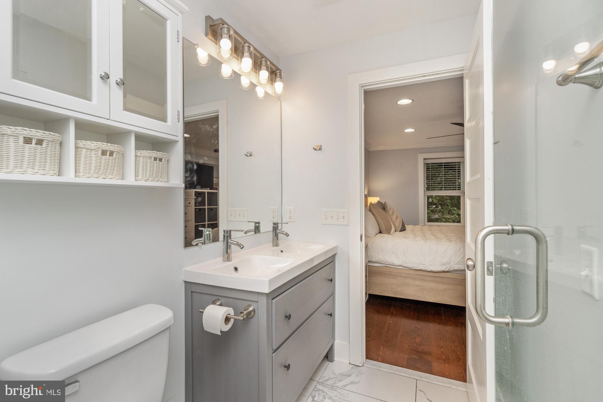217 East Cross Street Baltimore, MD 21230 - Photo 26 of 50 a bathroom with a sink a toilet and mirror