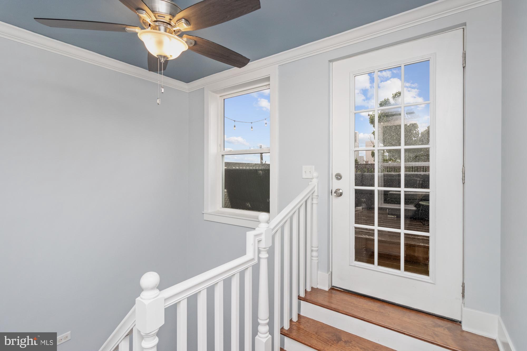 217 East Cross Street Baltimore, MD 21230 - Photo 32 of 50 a view of a hallway with windows and chandelier fan