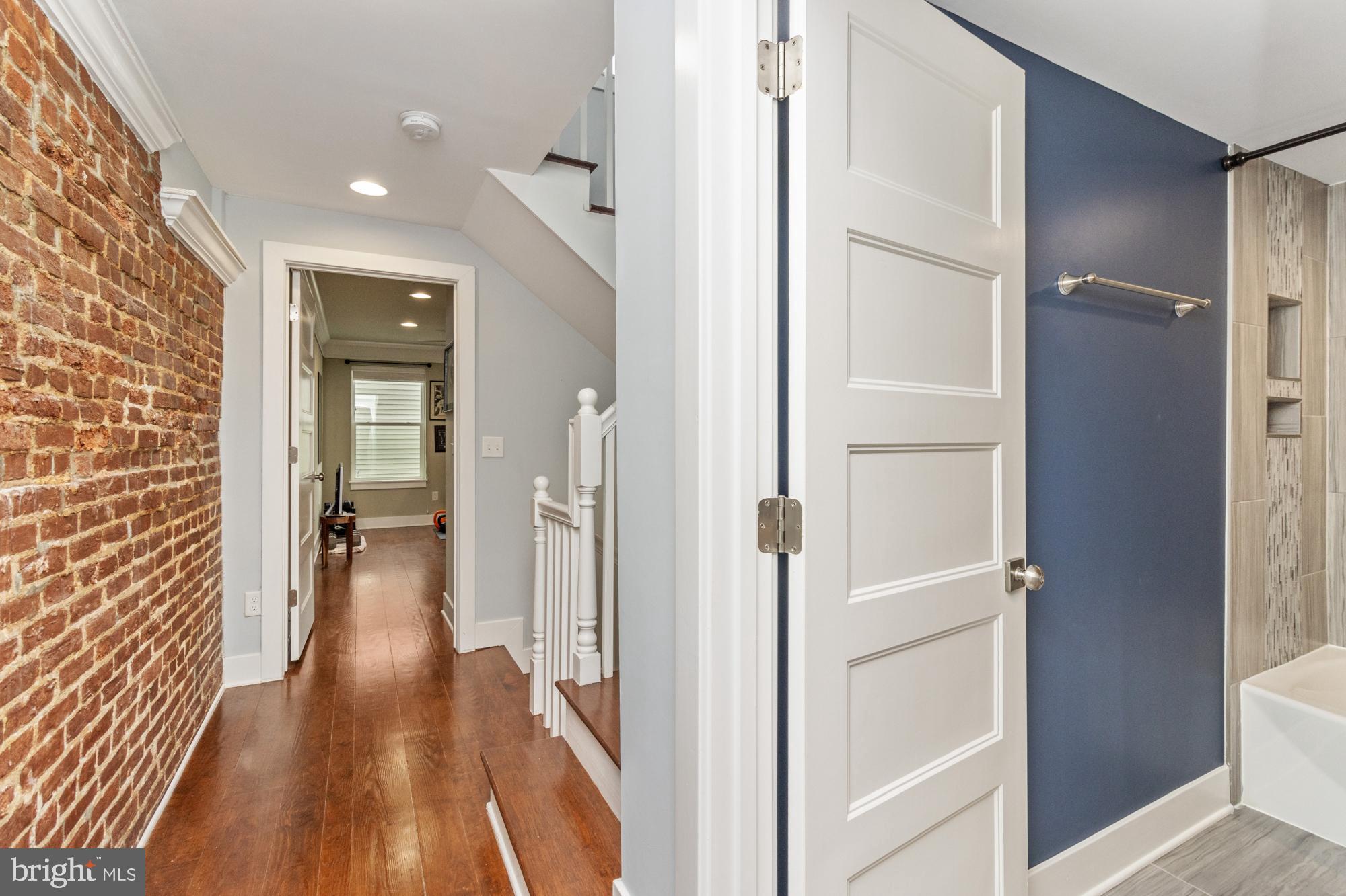 217 East Cross Street Baltimore, MD 21230 - Photo 37 of 50 a view of a hallway with wooden floor and staircase