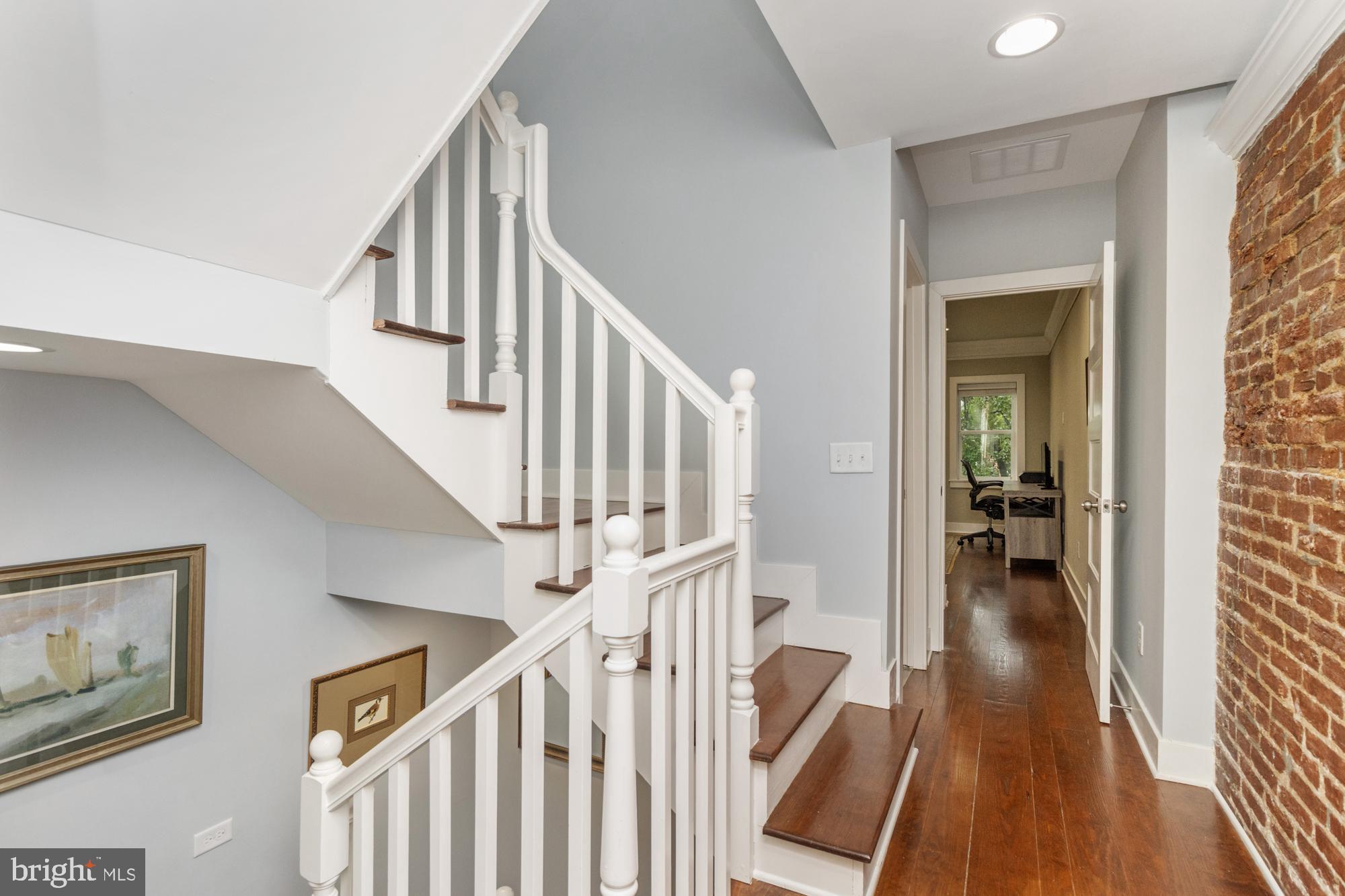 217 East Cross Street Baltimore, MD 21230 - Photo 38 of 50 a view of staircase with wooden floor and a rug