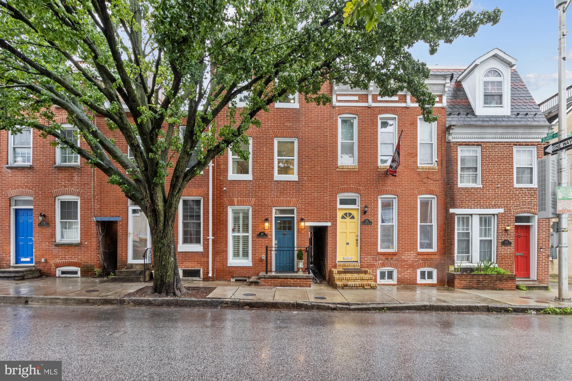 217 East Cross Street Baltimore, MD 21230 - Photo 49 of 50 a view of a brick house with large windows and a large tree