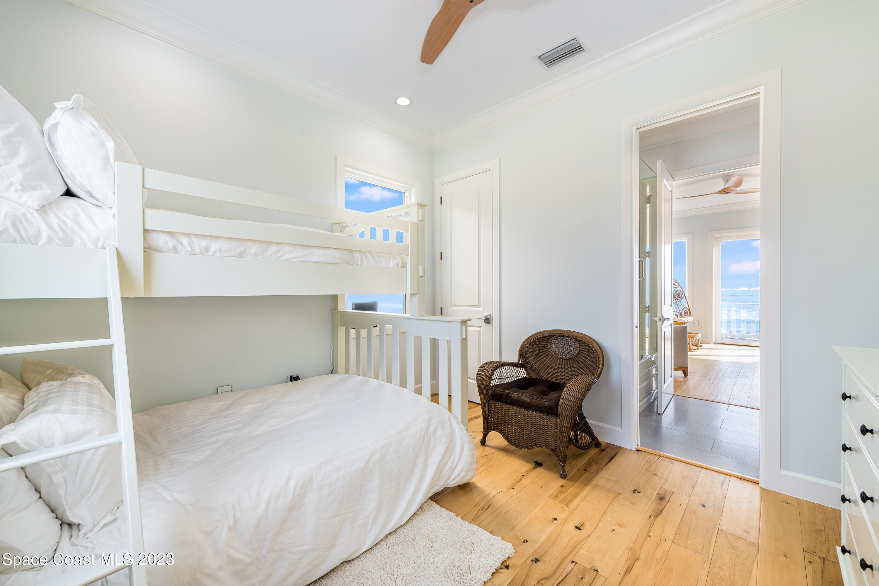 795 Shell Street Satellite Beach, FL 32937 - Photo 21 of 42 a bedroom with a bed and wooden floor