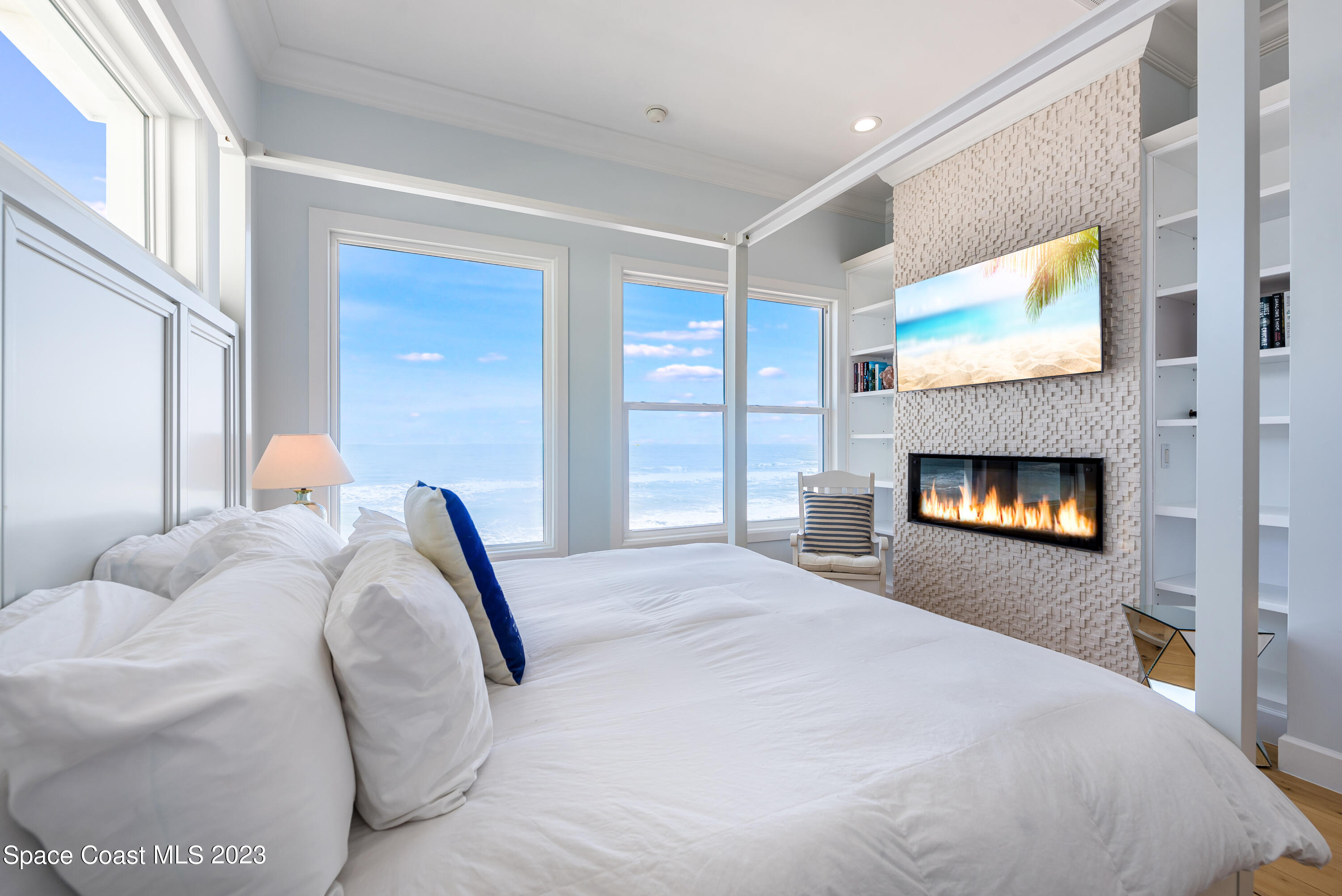 795 Shell Street Satellite Beach, FL 32937 - Photo 23 of 42 a bedroom with a bed and a fireplace