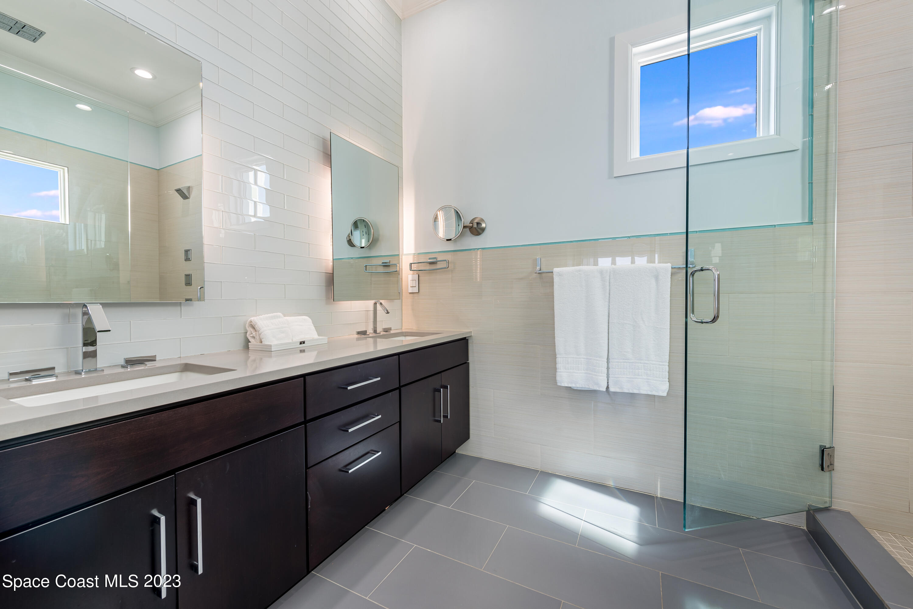 795 Shell Street Satellite Beach, FL 32937 - Photo 25 of 42 a bathroom with a double vanity sink and mirror