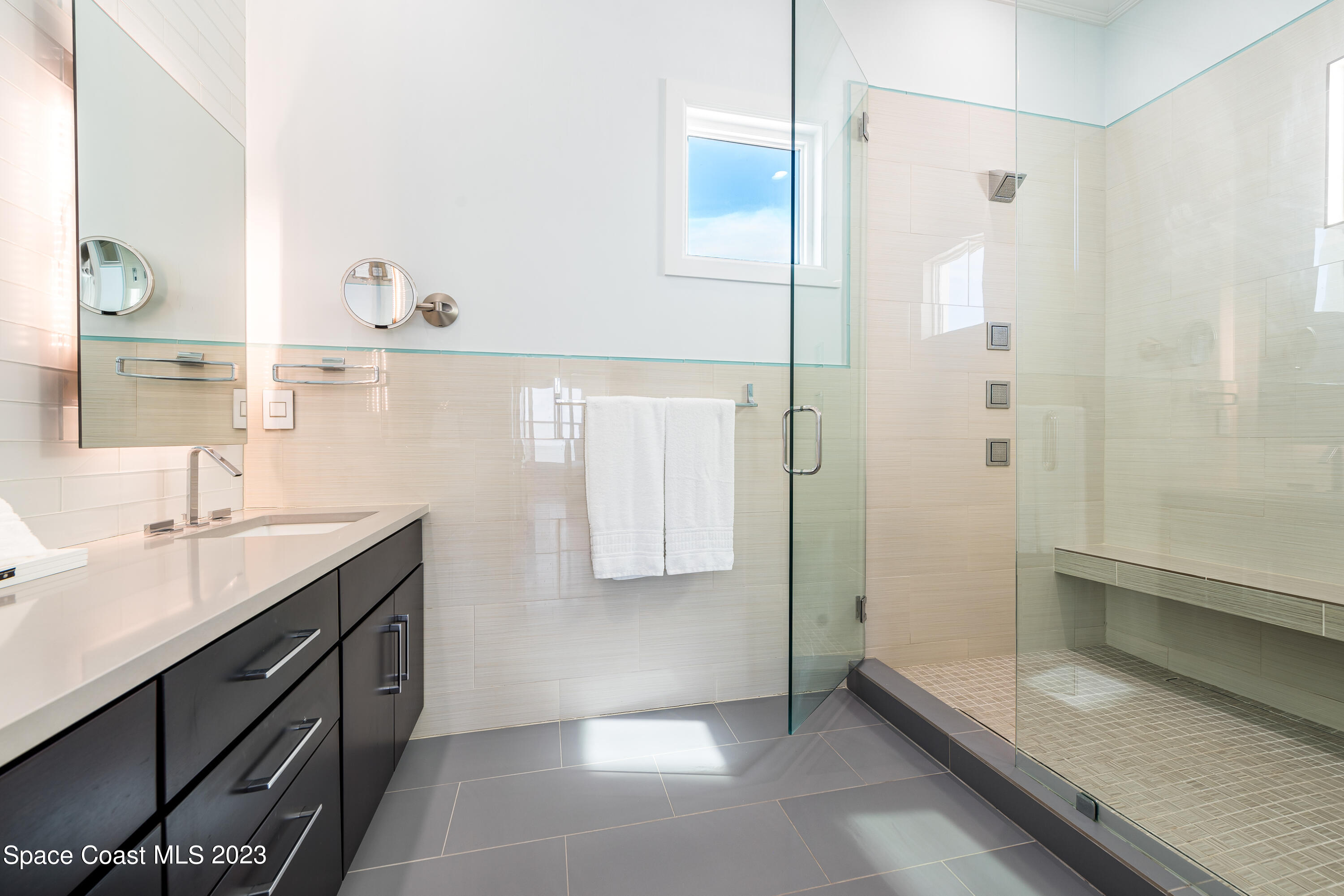 795 Shell Street Satellite Beach, FL 32937 - Photo 26 of 42 a spacious bathroom with a granite countertop sink a toilet and shower