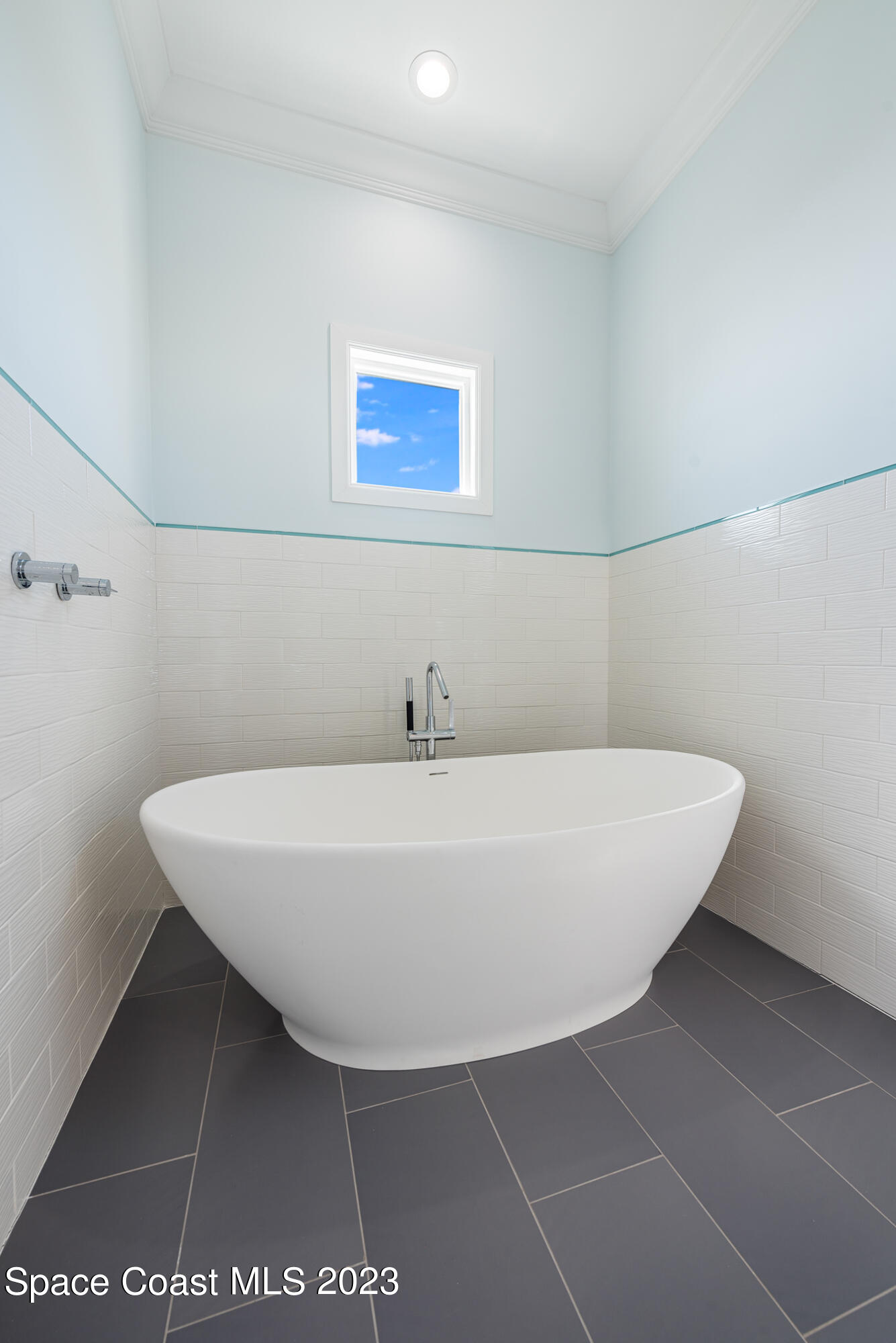 795 Shell Street Satellite Beach, FL 32937 - Photo 30 of 42 a white bath tub sitting in a bathroom