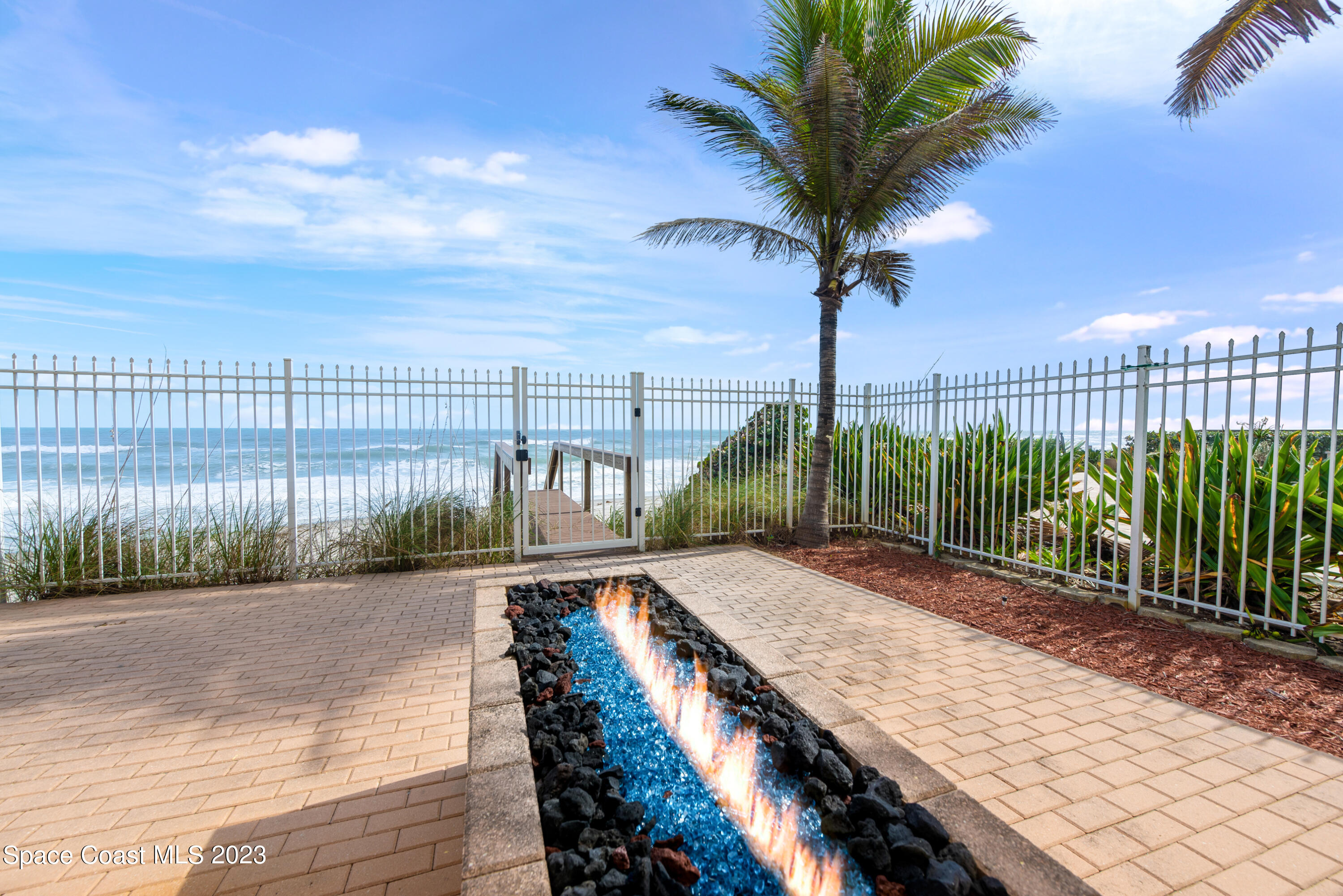 795 Shell Street Satellite Beach, FL 32937 - Photo 31 of 42 a view of a backyard with plants and wooden fence