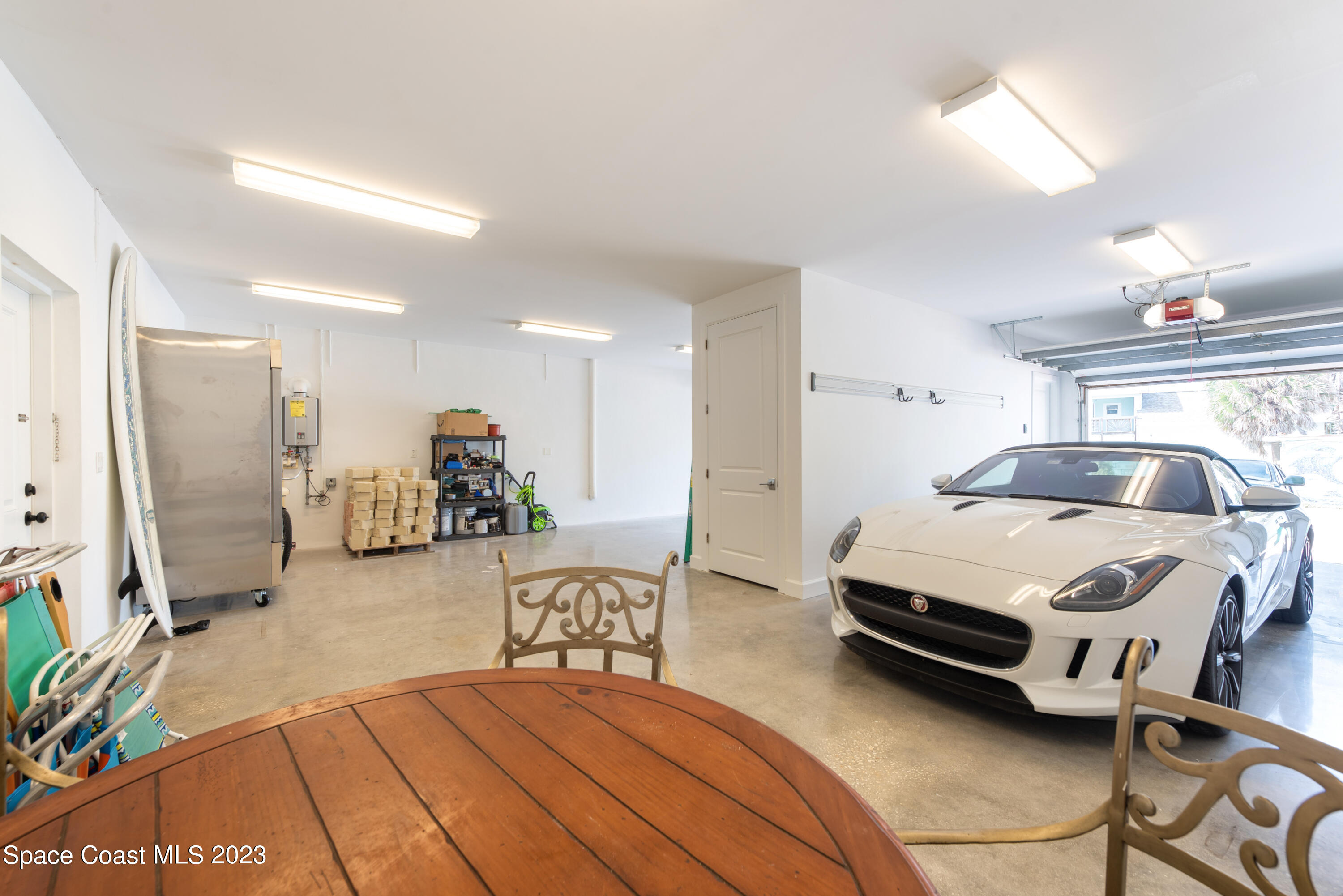 795 Shell Street Satellite Beach, FL 32937 - Photo 37 of 42 a bedroom with a bed and a chandelier