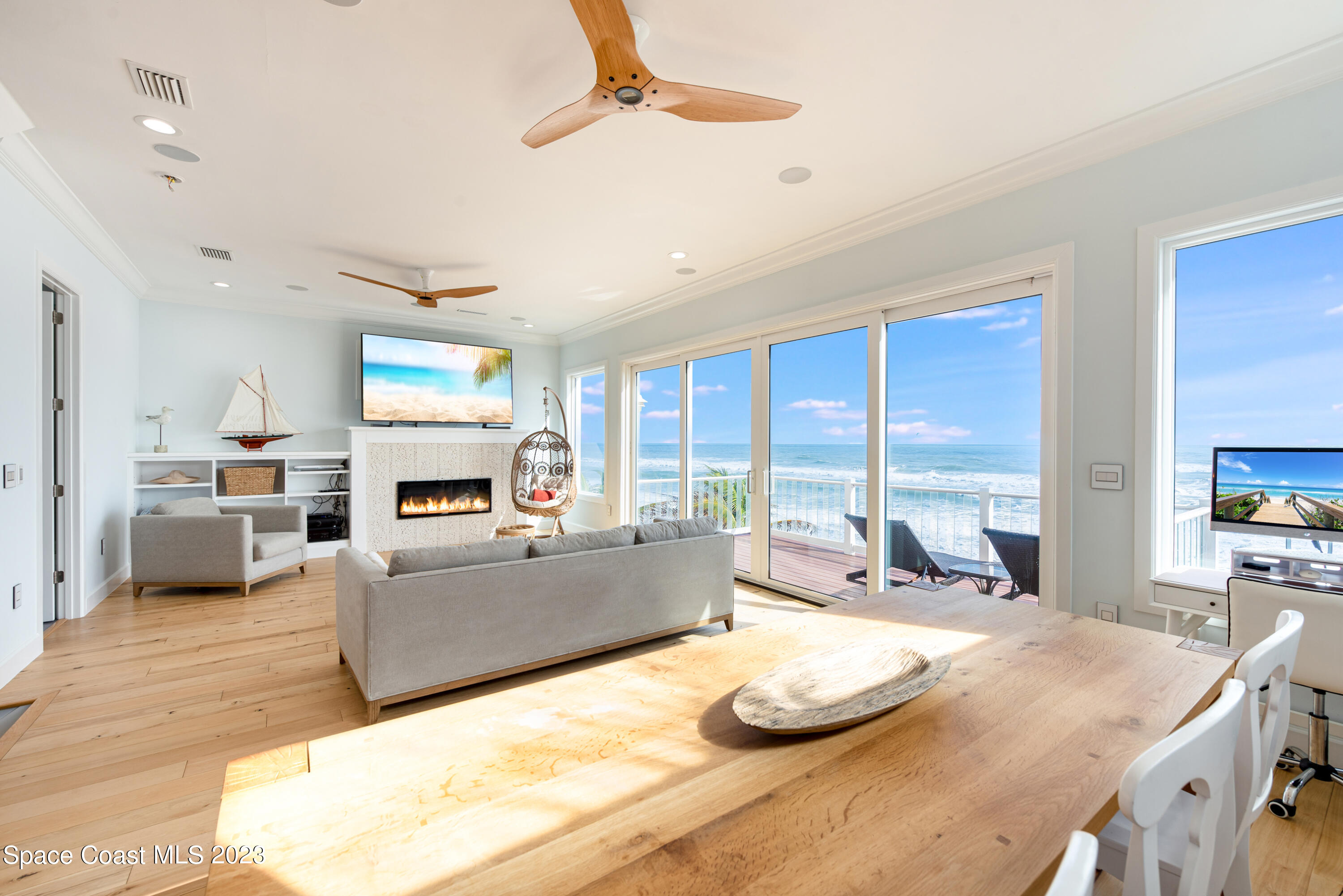 795 Shell Street Satellite Beach, FL 32937 - Photo 4 of 42 a large kitchen with kitchen island a large window cabinets a sink and stainless steel appliances
