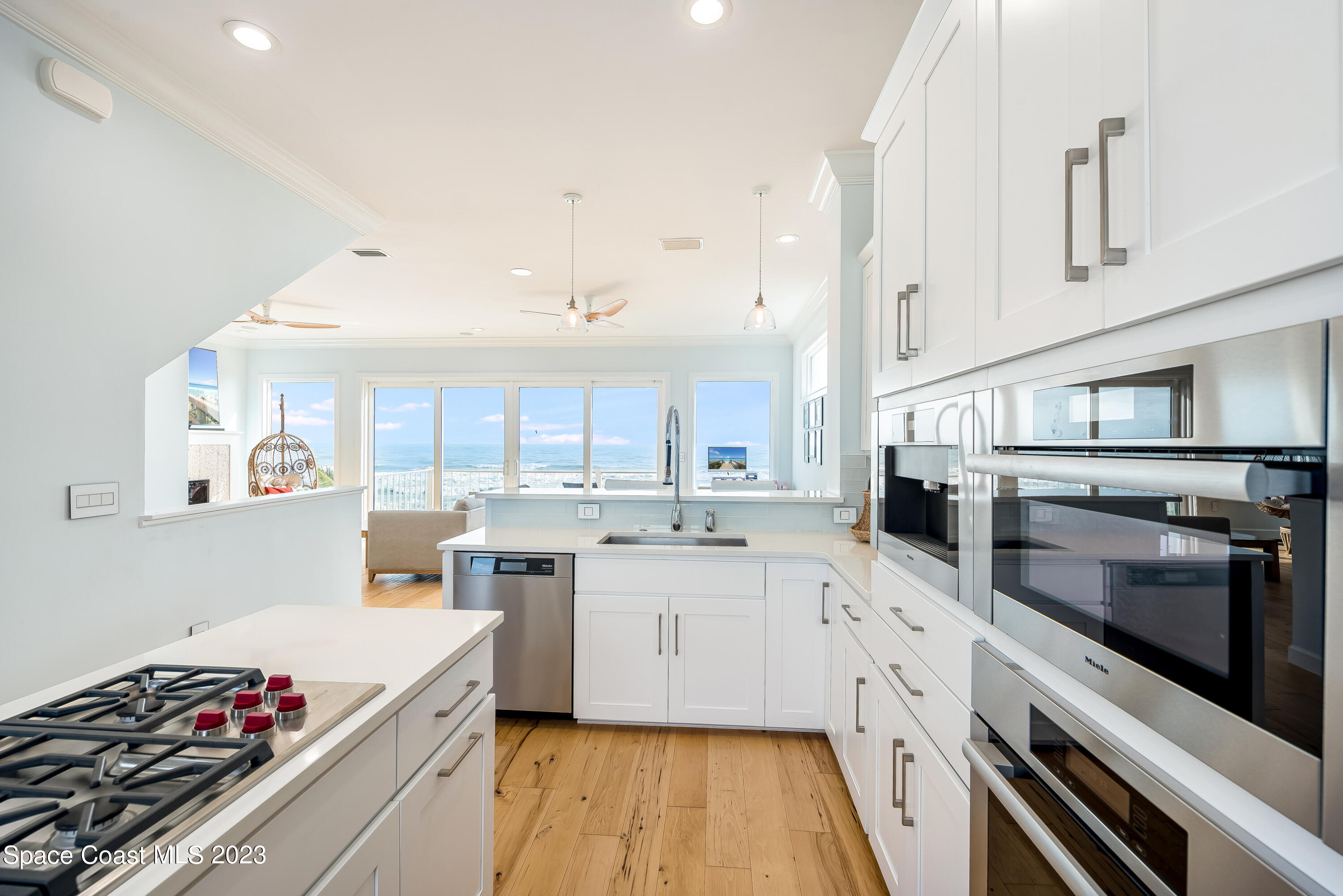 795 Shell Street Satellite Beach, FL 32937 - Photo 7 of 42 a kitchen with a sink a stove and cabinets