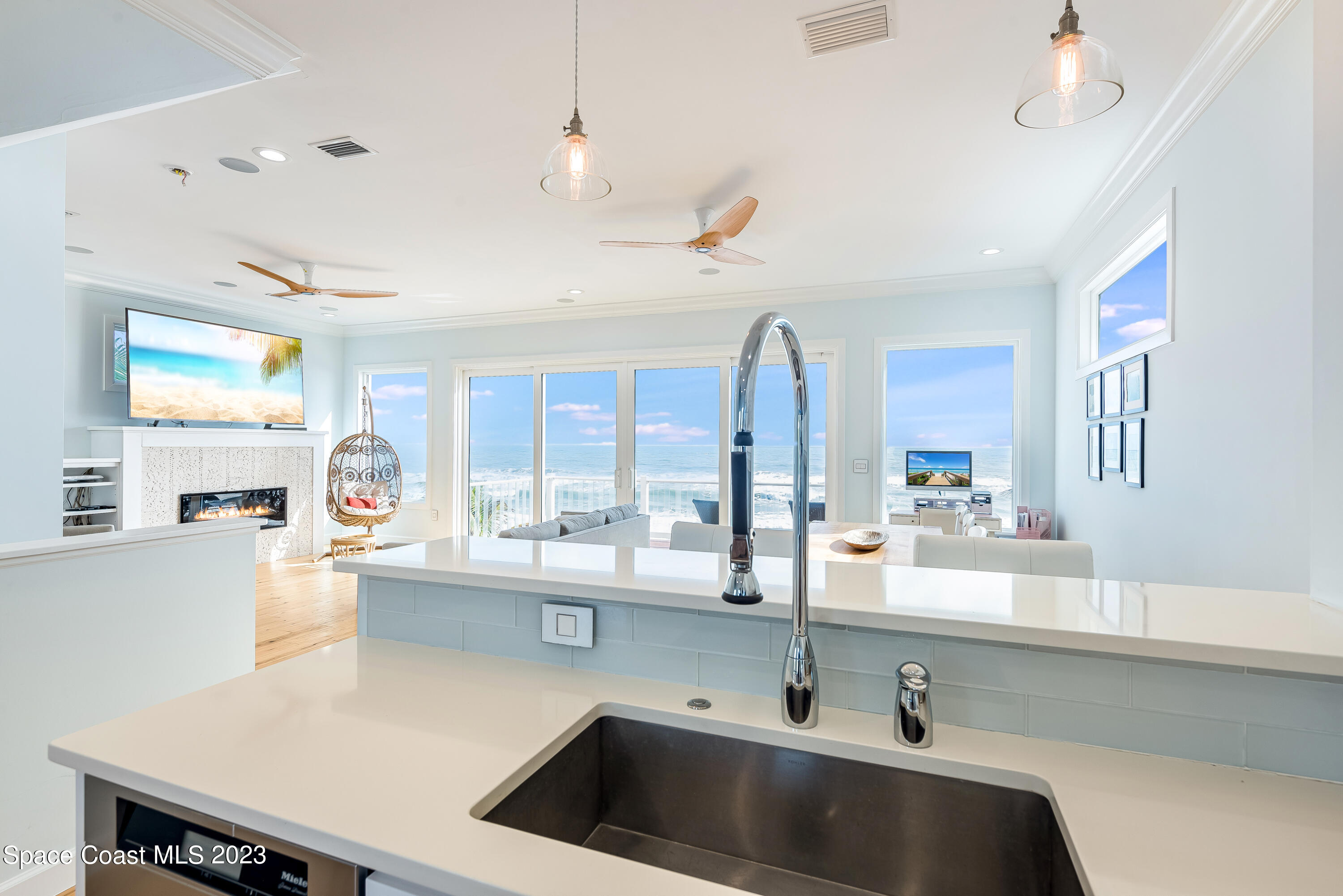 795 Shell Street Satellite Beach, FL 32937 - Photo 8 of 42 a kitchen with a sink a stove and a window