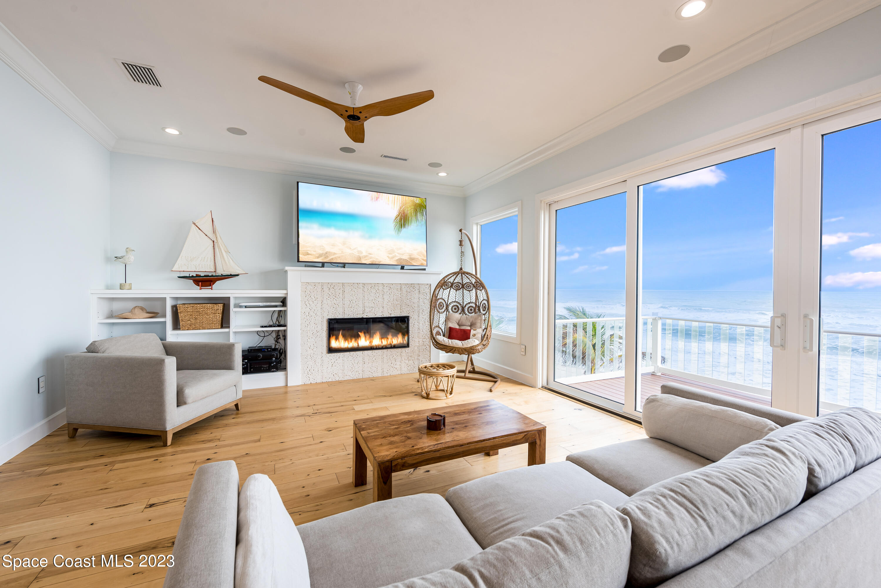 795 Shell Street Satellite Beach, FL 32937 - Photo 10 of 42 a living room with furniture a large window and a fireplace