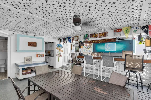 a living room with fireplace furniture and a large window