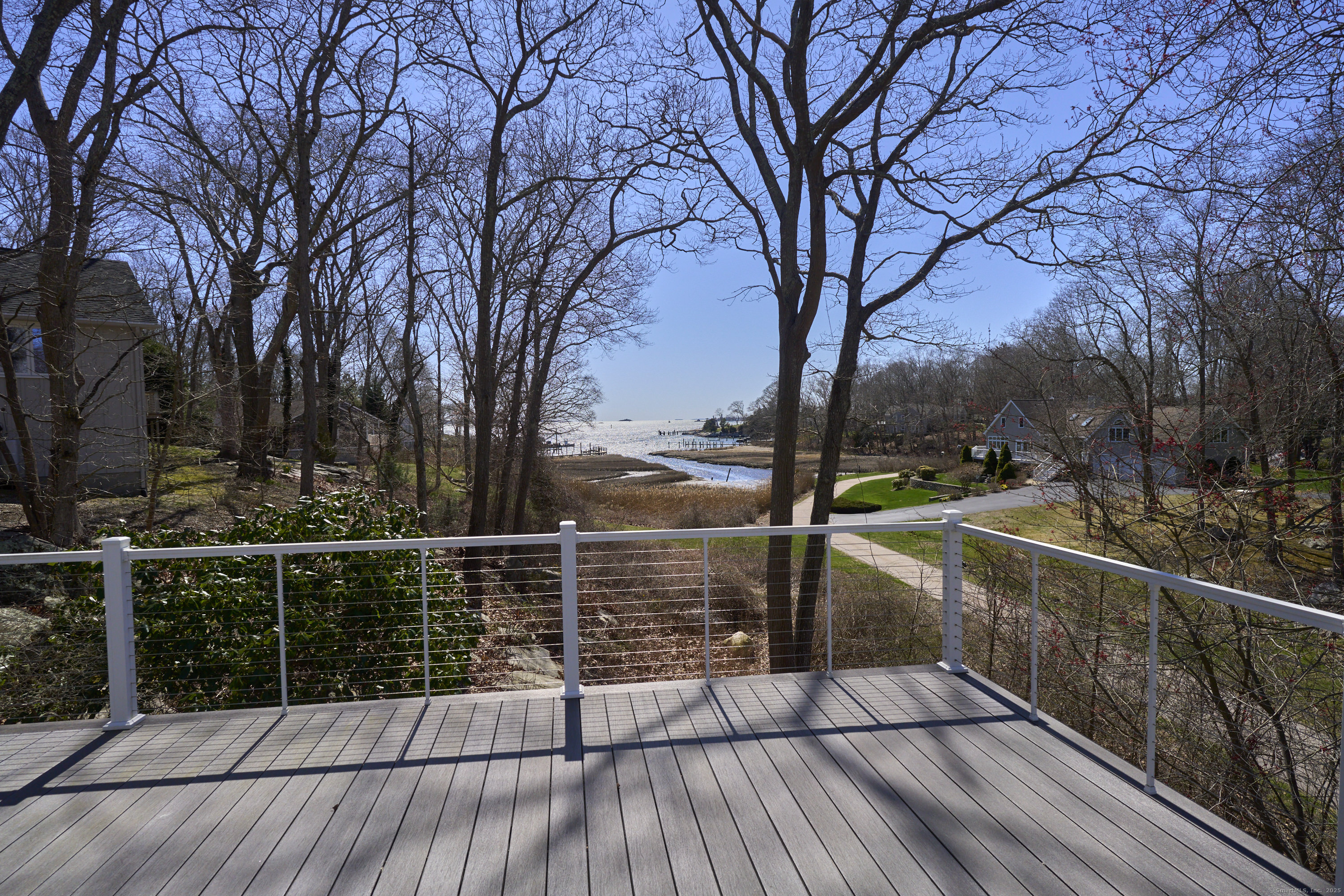 a view of a balcony with wooden floor and fence