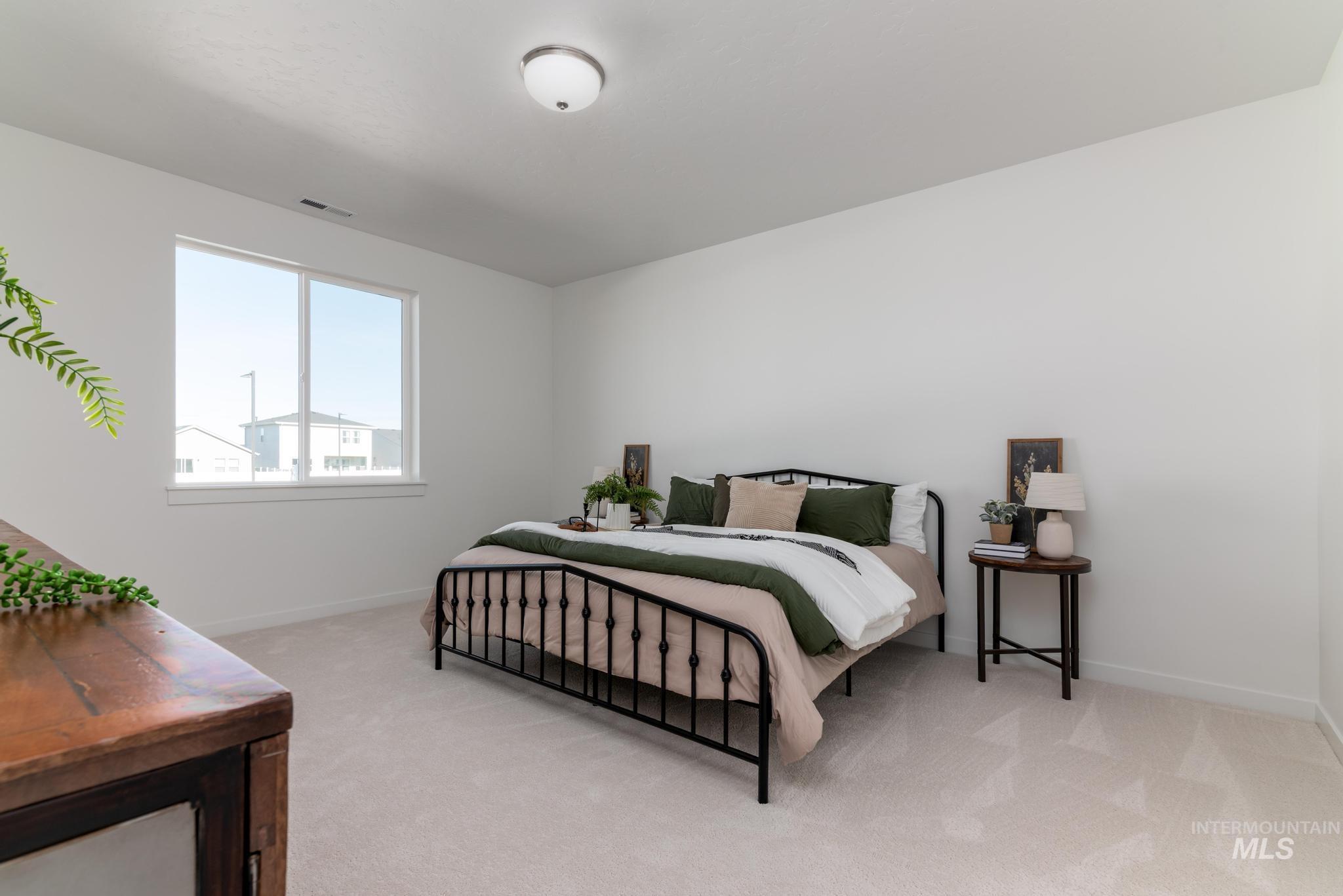 8409 South Wavecrest Avenue Kuna, ID 83634 - Photo 7 of 12 Carpeted bedroom featuring baseboards