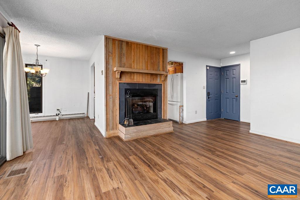 2025 Stone Ridge Wintergreen, VA 22967 - Photo 4 of 23 a view of an empty room with wooden floor fireplace and a window