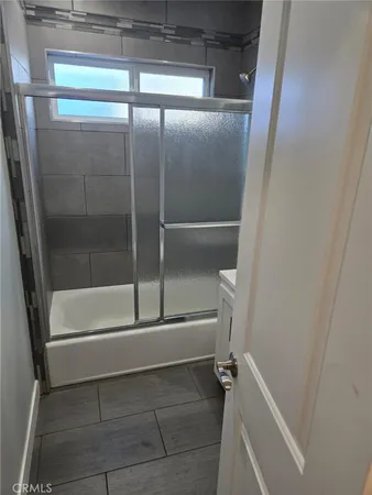 a bathroom with a glass shower door