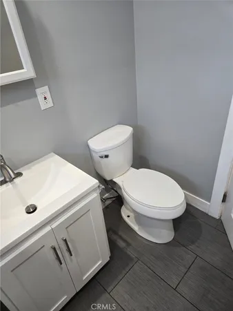 a white toilet sitting next to a white sink