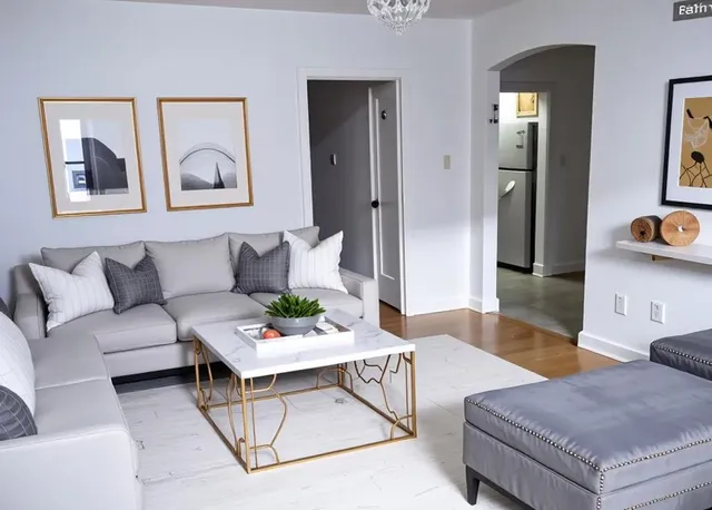 a living room with furniture and wooden floor