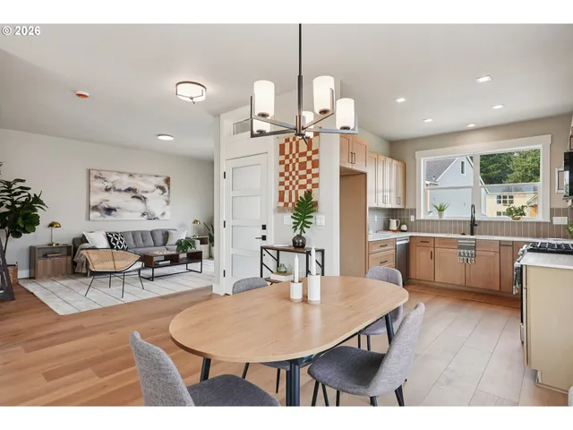 a kitchen with a table chairs and a living room
