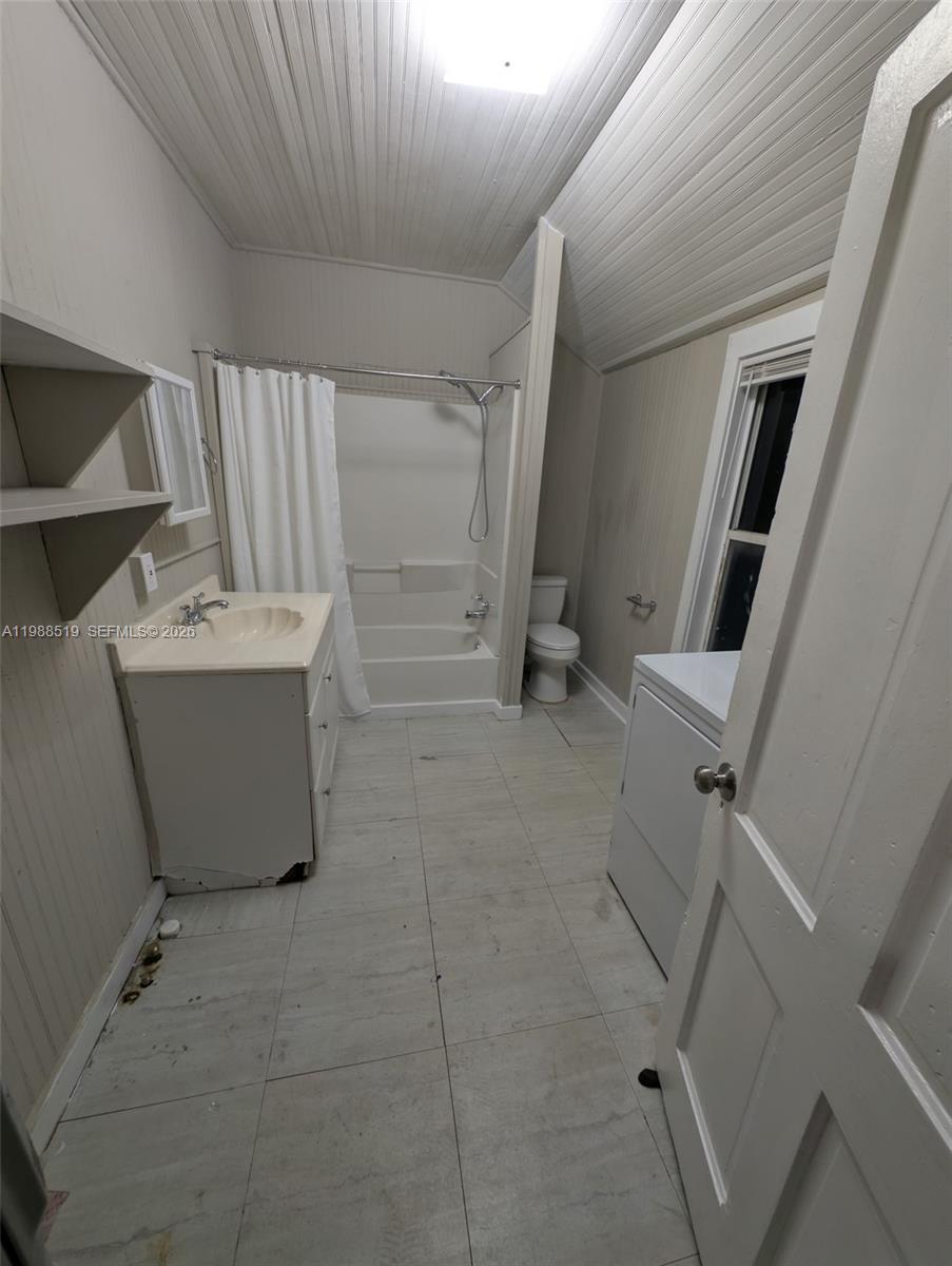 700 Boston Avenue, Unit B Fort Pierce, FL 34950 - Photo 11 of 12 wooden floor in an empty room with a window
