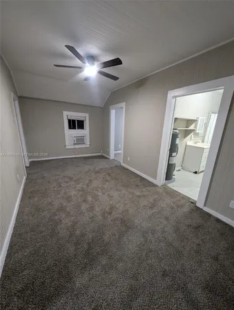 a view of a livingroom with a ceiling fan and window
