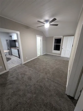a view of a livingroom with a ceiling fan and window