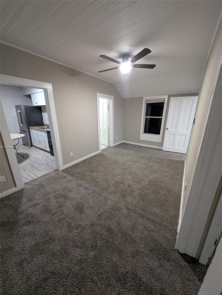 700 Boston Avenue, Unit B Fort Pierce, FL 34950 - Photo 9 of 12 a view of a livingroom with a ceiling fan and window