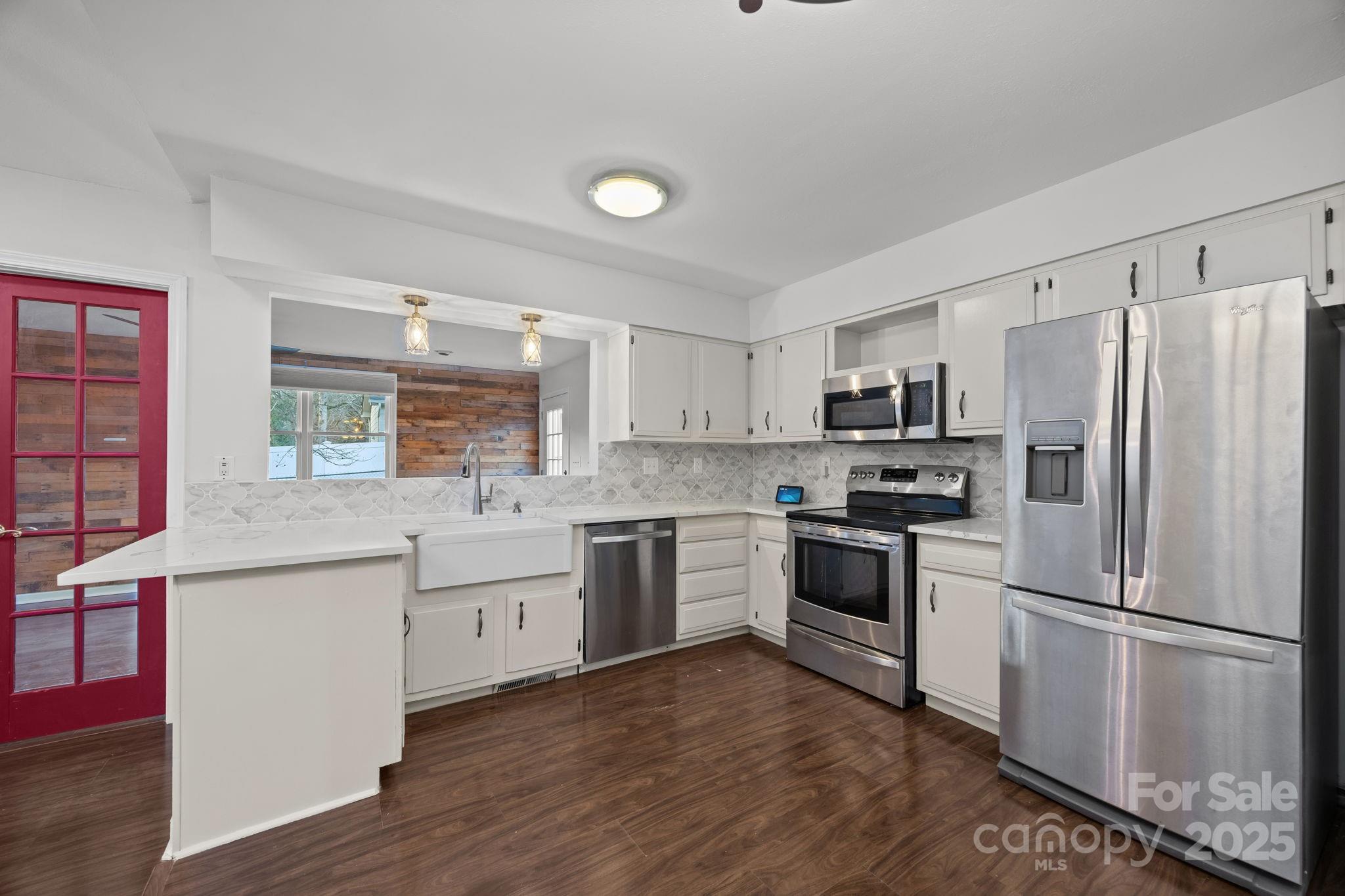 17 Berry Lane Fletcher, NC 28732 - Photo 13 of 47 a kitchen with white cabinets and stainless steel appliances