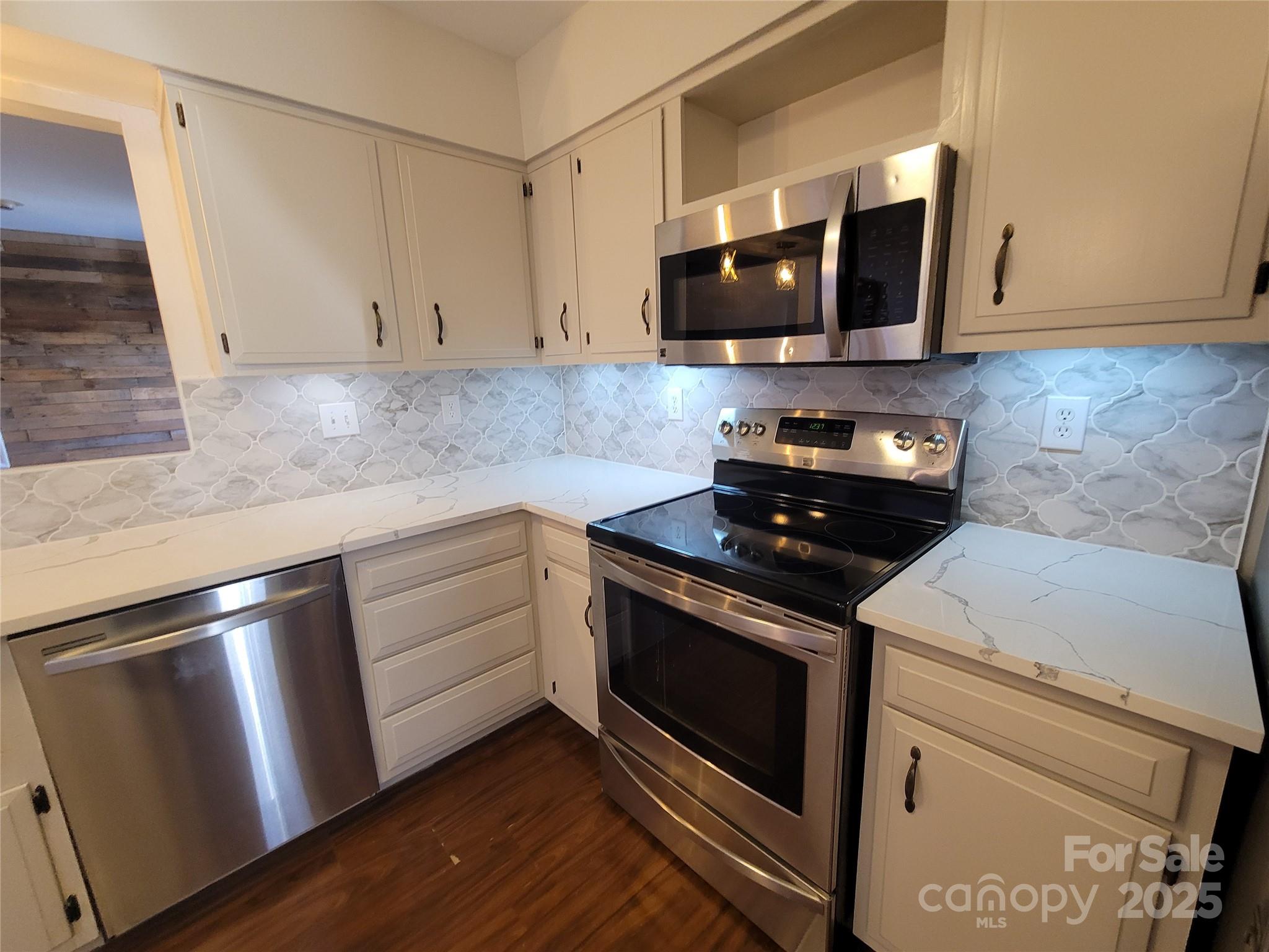 17 Berry Lane Fletcher, NC 28732 - Photo 15 of 47 a kitchen with granite countertop white cabinets and stainless steel appliances
