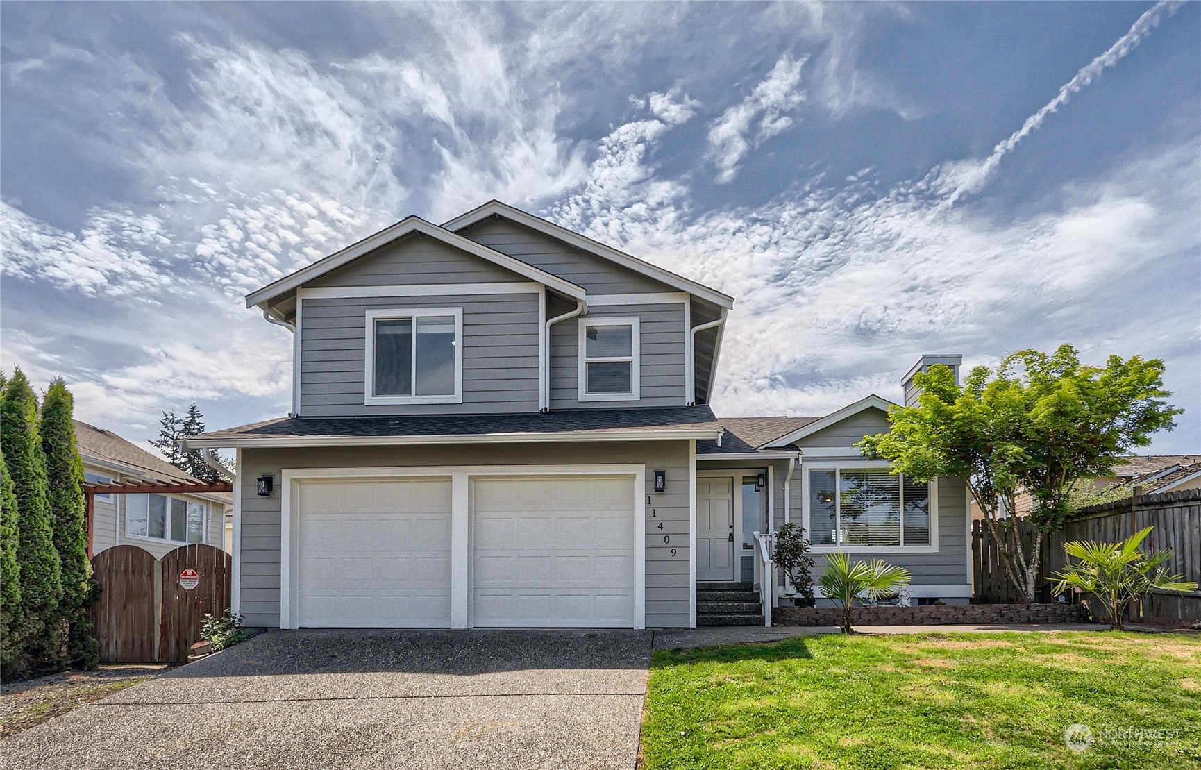 11409 Southeast 177th Place Renton, WA 98055 - Photo 1 of 27 a front view of a house with garden