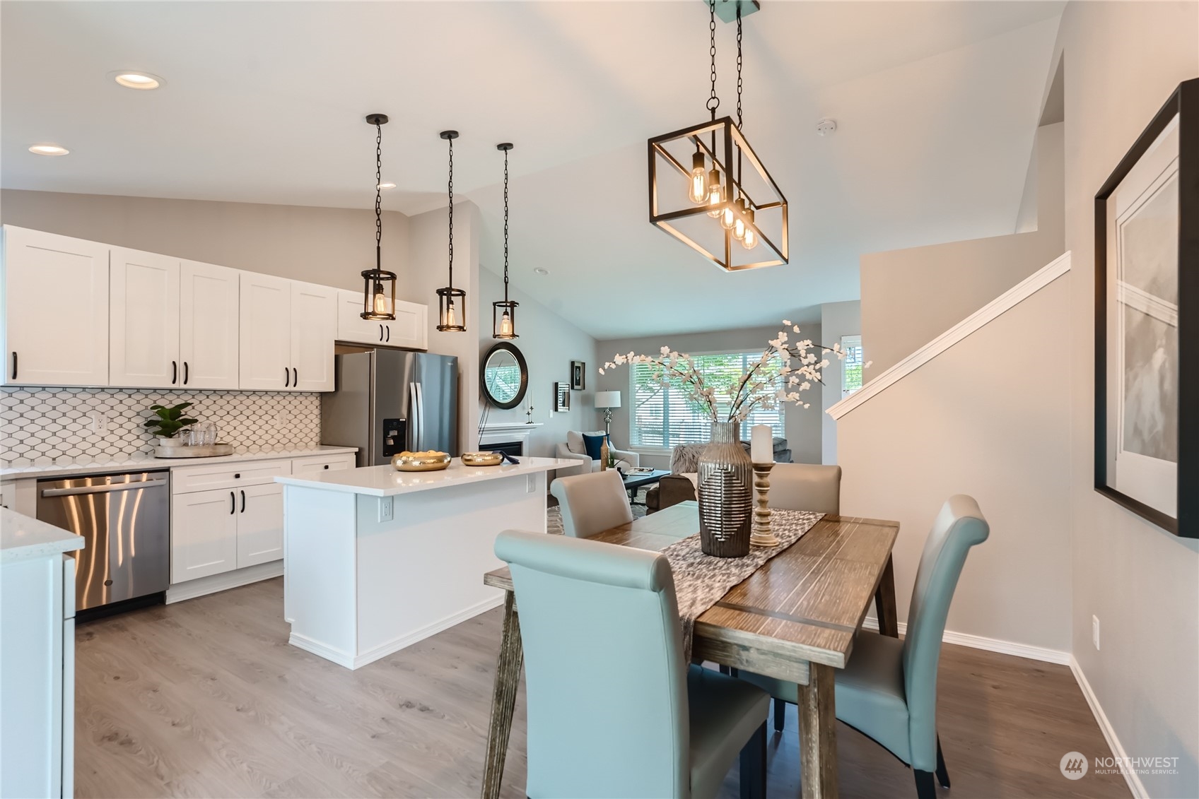 11409 Southeast 177th Place Renton, WA 98055 - Photo 6 of 27 a kitchen with stainless steel appliances granite countertop a stove a sink a dining table and chairs with wooden floor