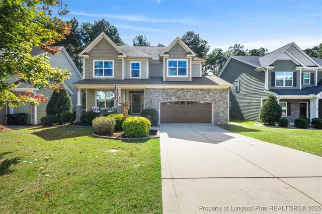 a front view of a house with a yard and garage