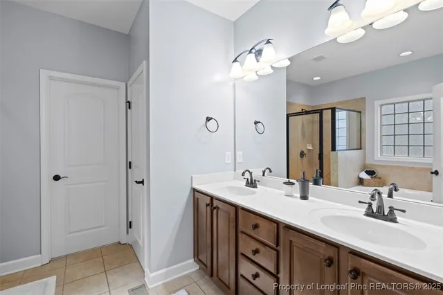 a spacious bathroom with a double vanity sink mirror and shower