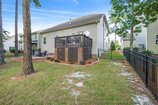 a view of a house with backyard and a tree