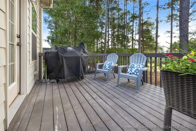 a view of deck with table and chairs and wooden floor