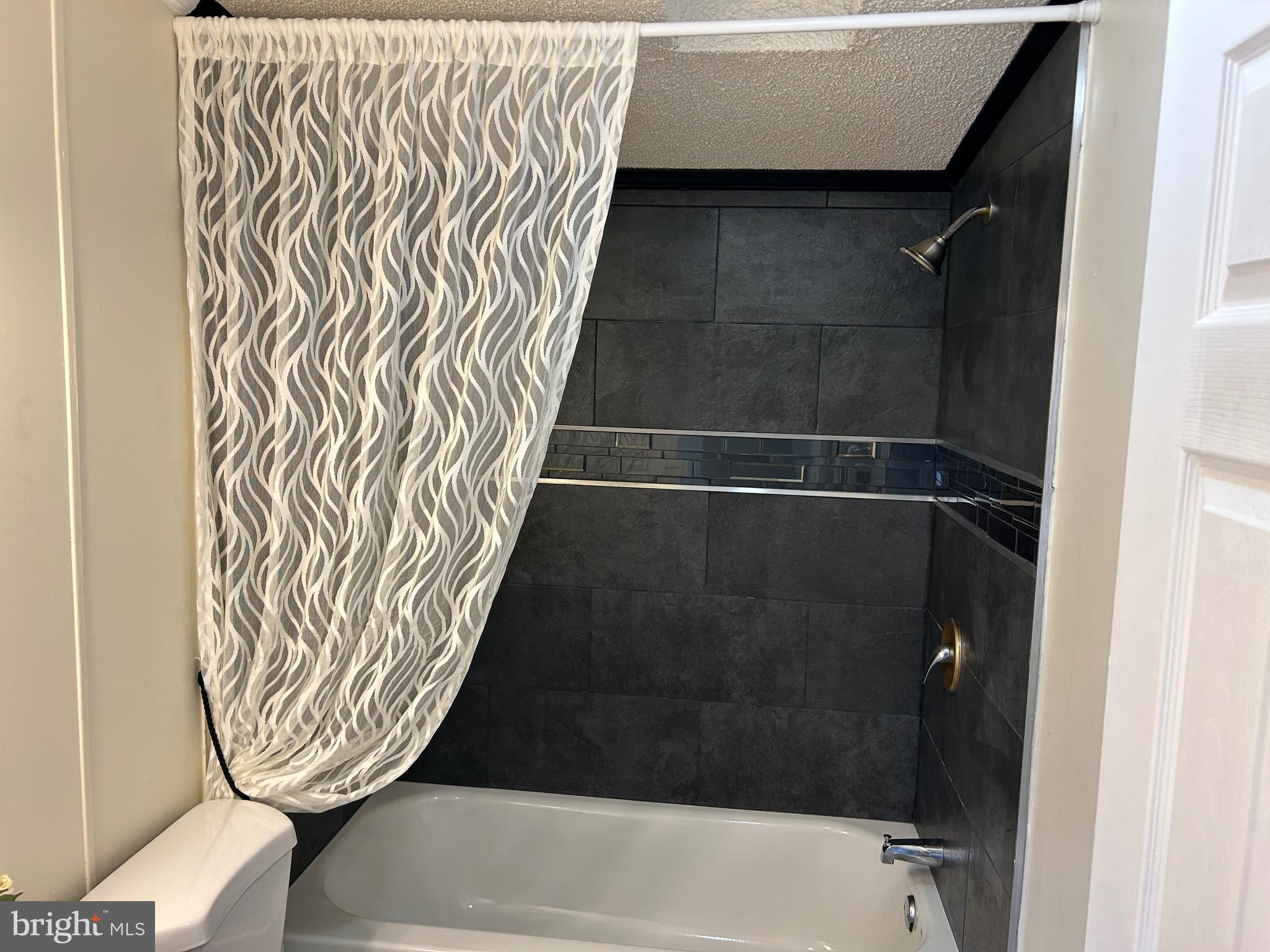 2139 Meredith Way, Unit A679 Bear, DE 19701 - Photo 23 of 38 a bathroom with a bathtub and shower