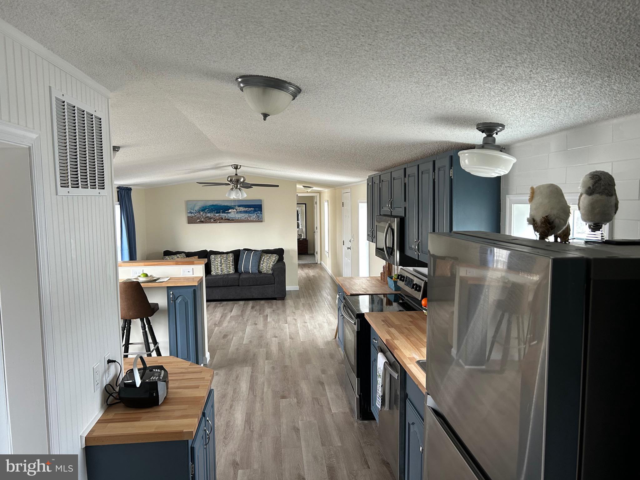 2139 Meredith Way, Unit A679 Bear, DE 19701 - Photo 5 of 38 a living room with furniture a dining table and wooden floor