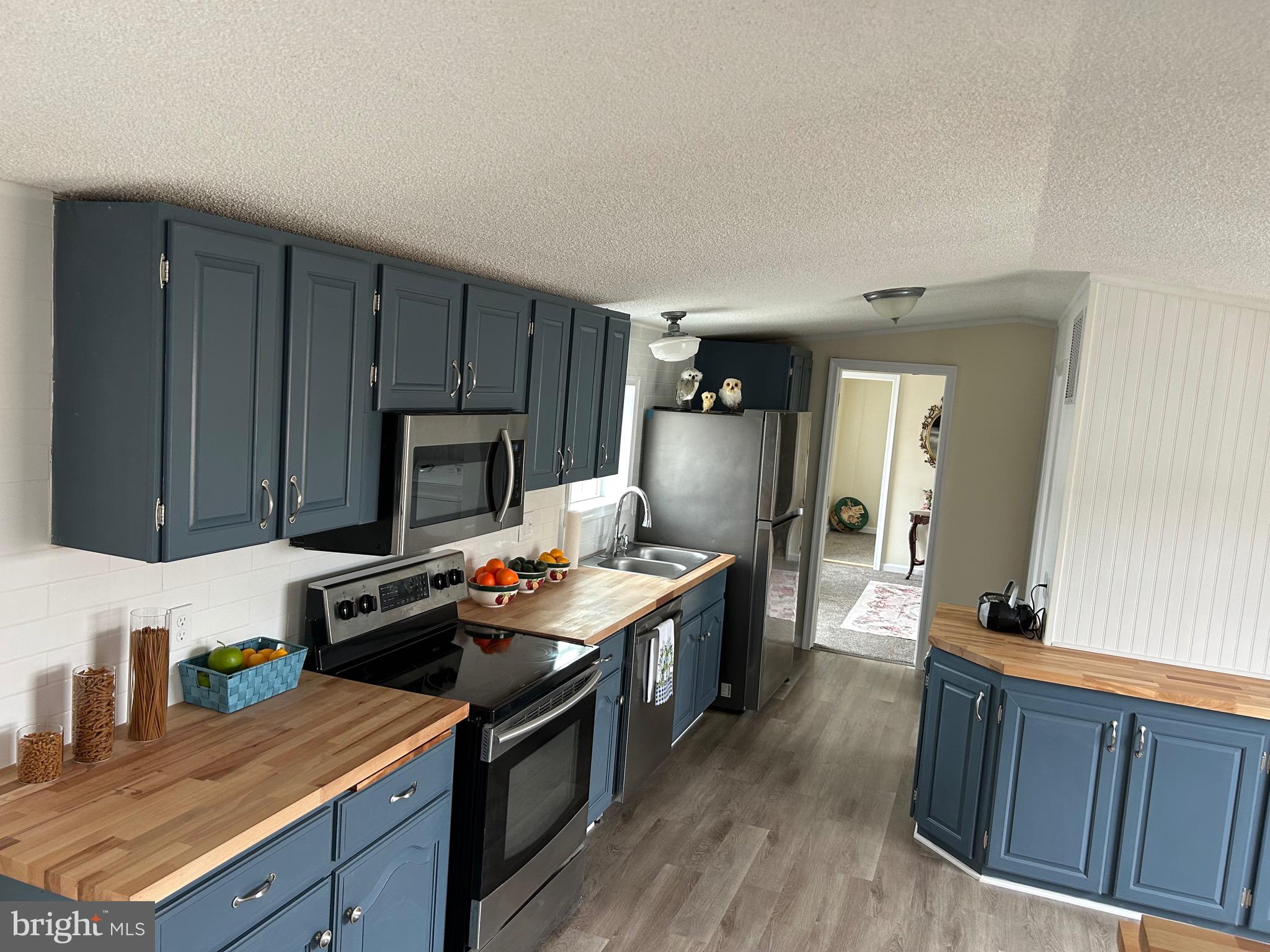 2139 Meredith Way, Unit A679 Bear, DE 19701 - Photo 7 of 38 a kitchen with wooden cabinets and a stove top oven