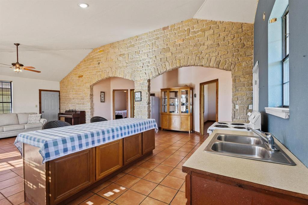 5777 State Highway 160 Whitewright, TX 75491 - Photo 13 of 36 a living room with a bed furniture and a fireplace