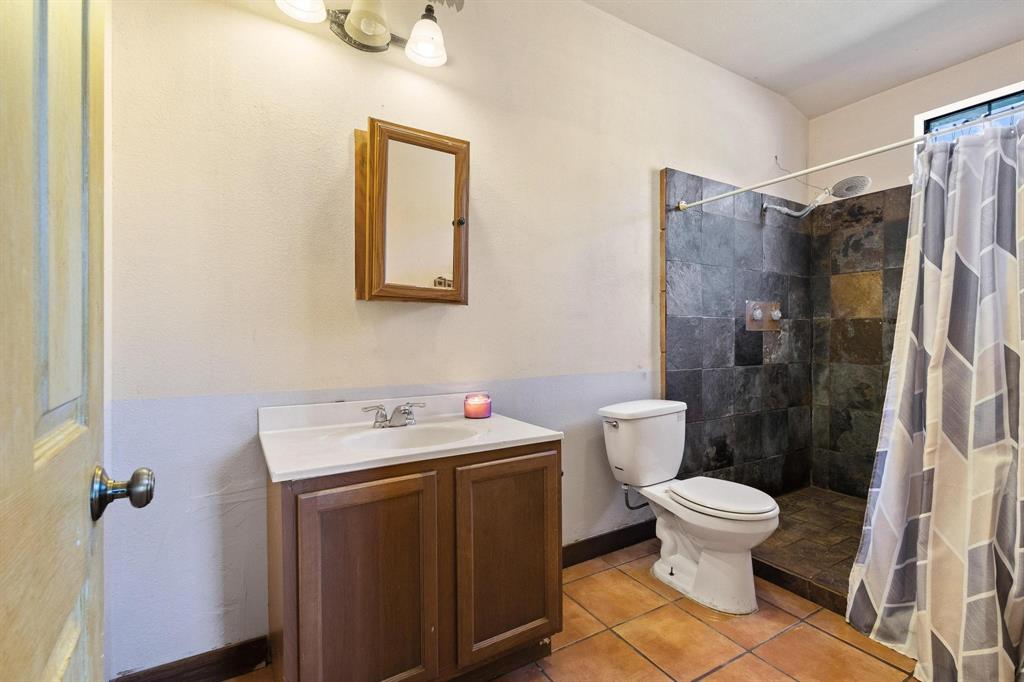 5777 State Highway 160 Whitewright, TX 75491 - Photo 23 of 36 a bathroom with a toilet sink and shower