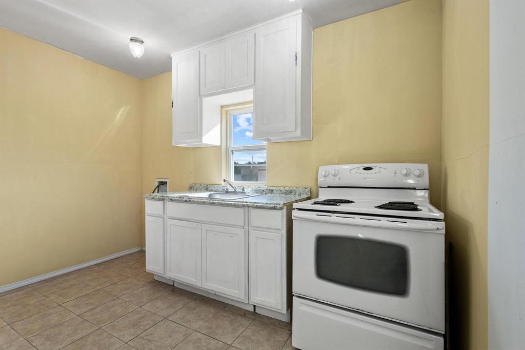 5777 State Highway 160 Whitewright, TX 75491 - Photo 28 of 36 a kitchen with a stove sink and cabinets