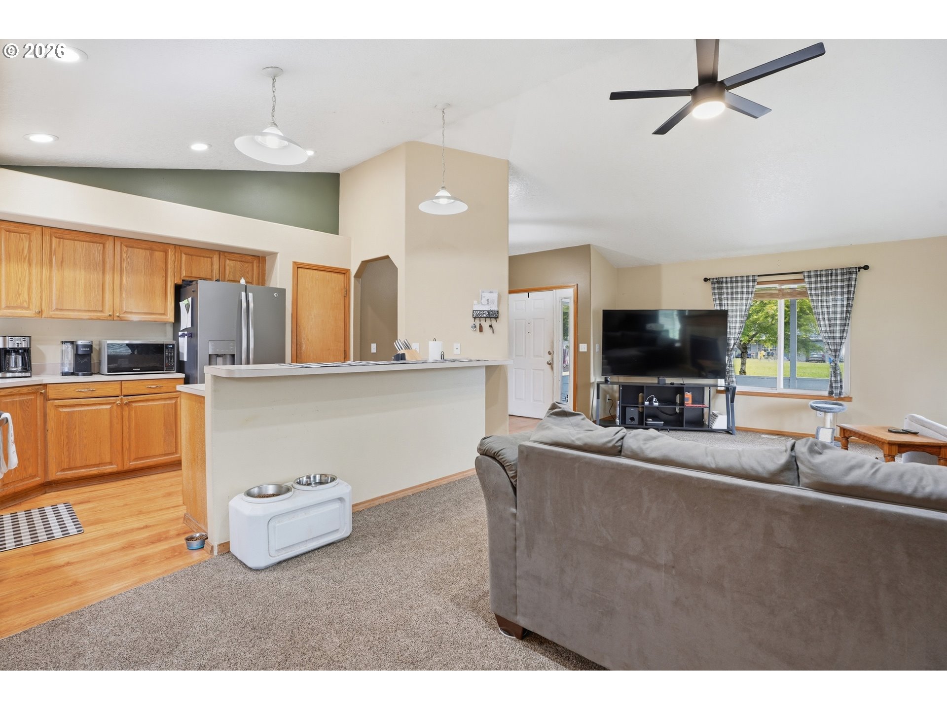 105 Toliver Road Molalla, OR 97038 - Photo 7 of 34 a living room with stainless steel appliances kitchen island granite countertop furniture and a flat screen tv