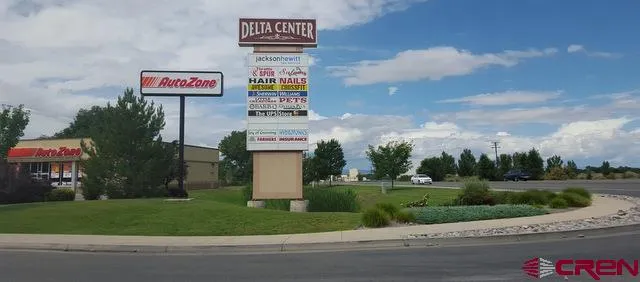 a city view with cars parked on the roadside