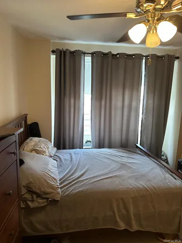 a bedroom with a bed and a mirror