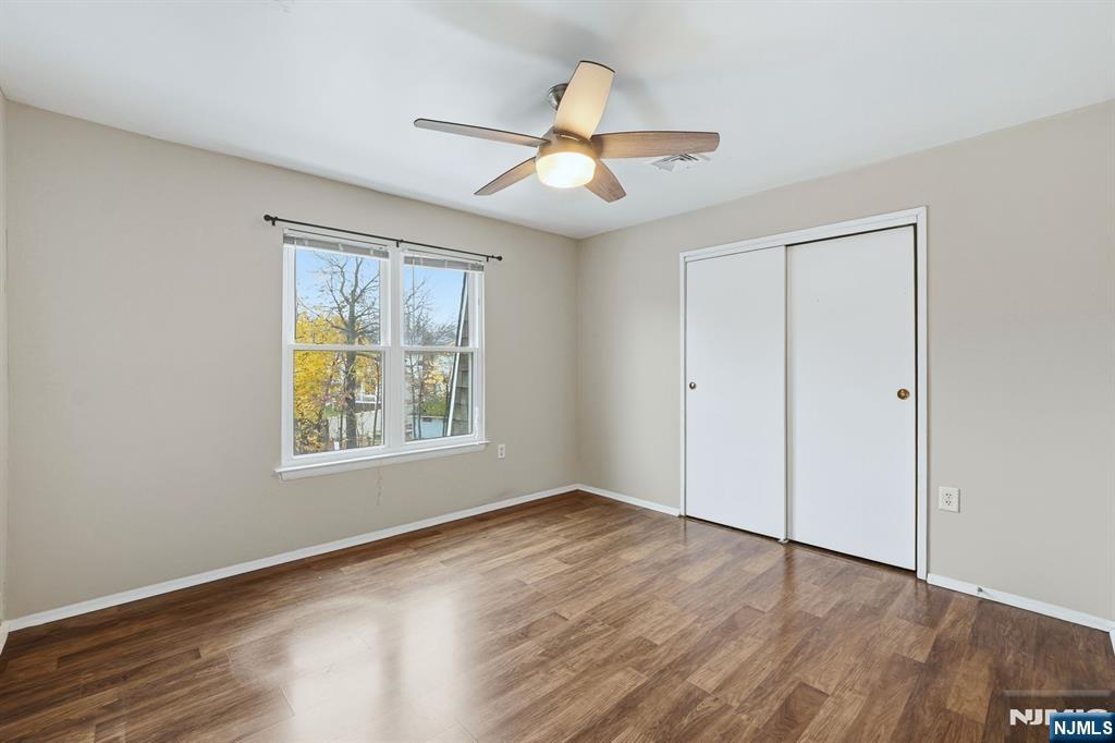 253 Park Avenue, Unit 305 Rutherford, NJ 07070 - Photo 3 of 7 a view of an empty room with wooden floor and a window